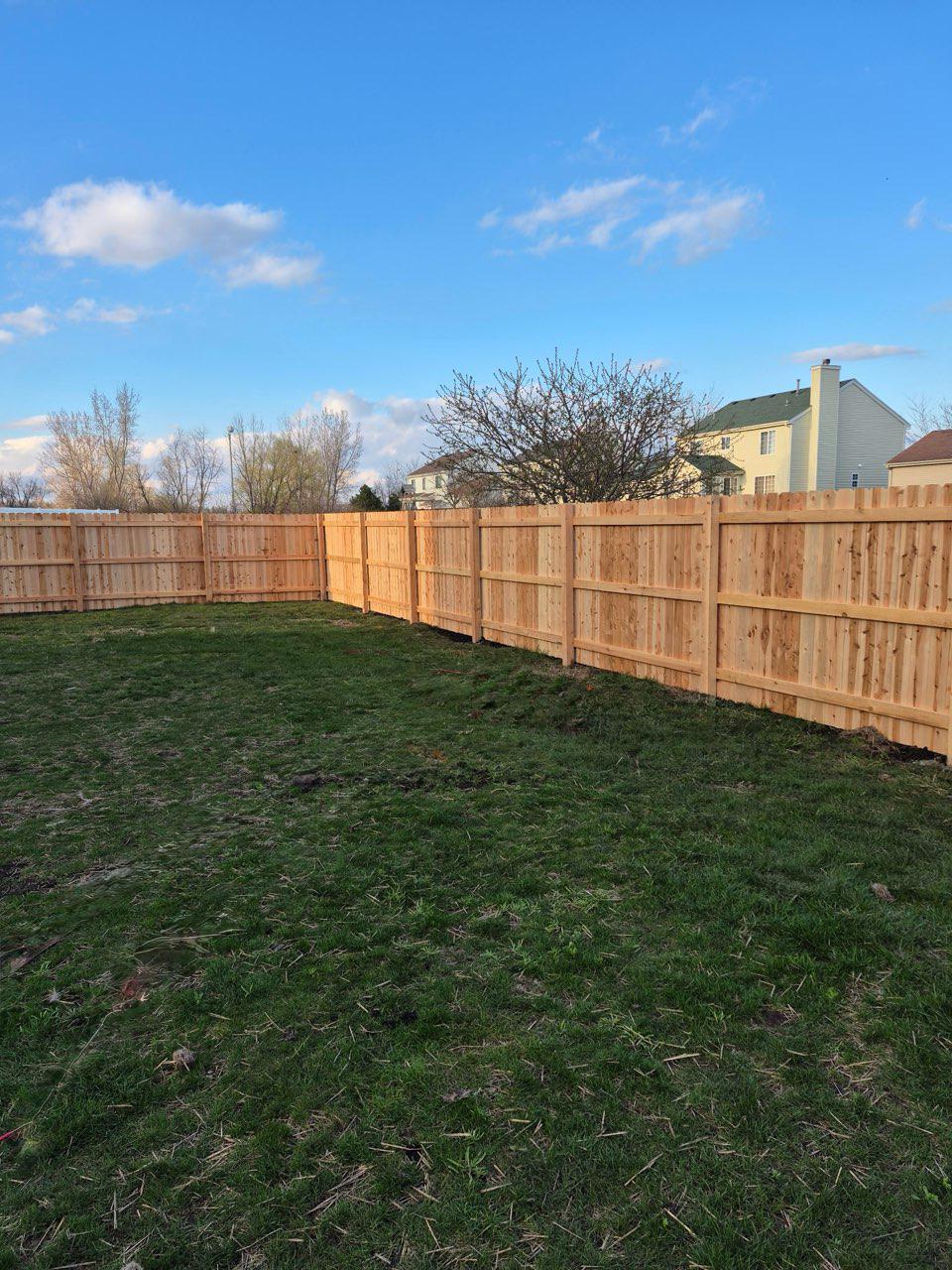 wood stockade fence installed by top rail fence