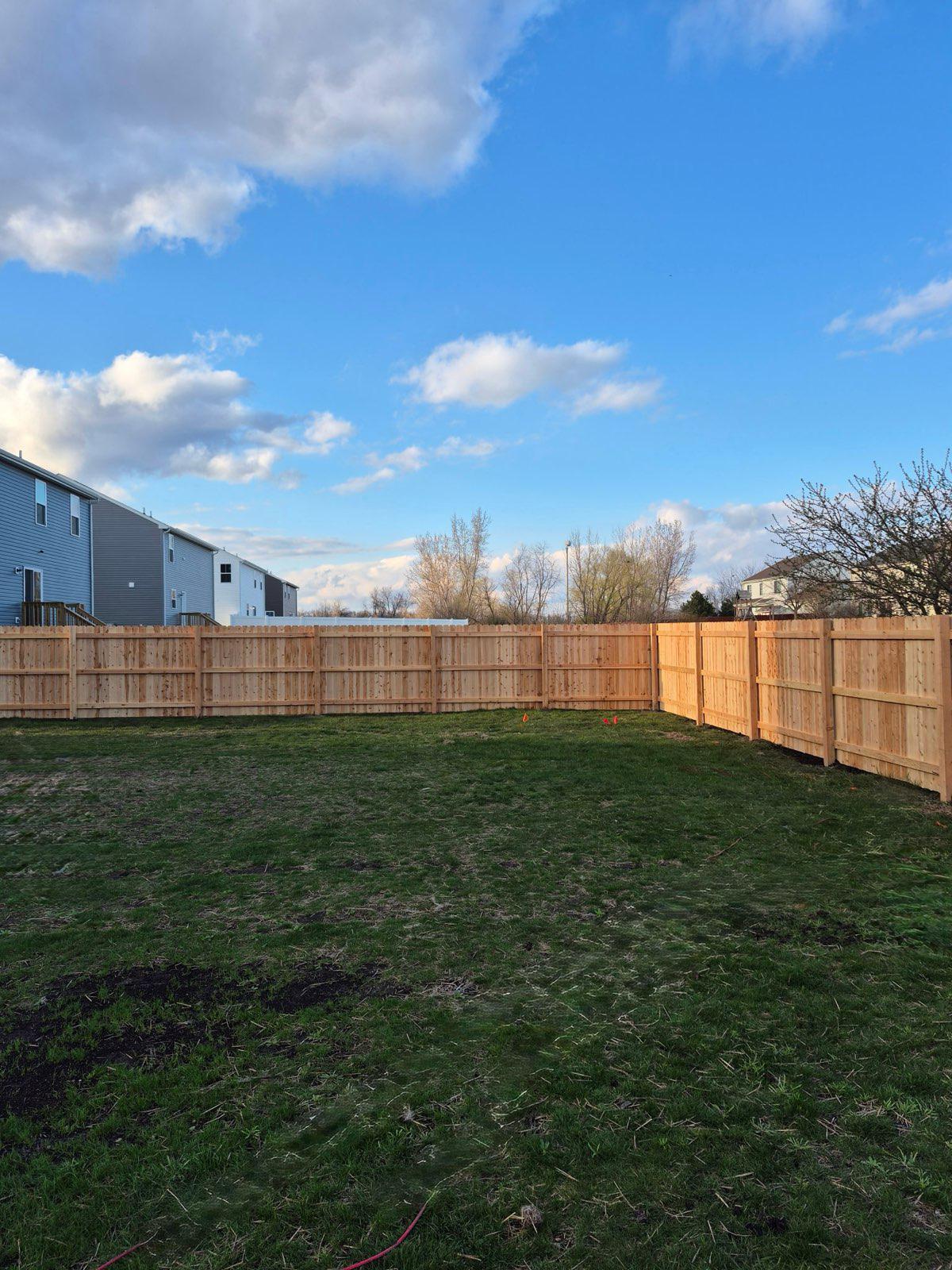 wood stockade fence installed by top rail fence
