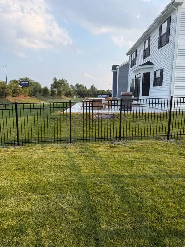 ornamental metal fence installed by top rail fence