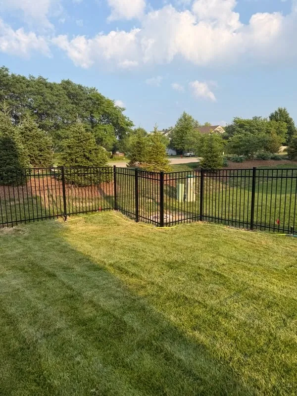 ornamental metal fence installed by top rail fence