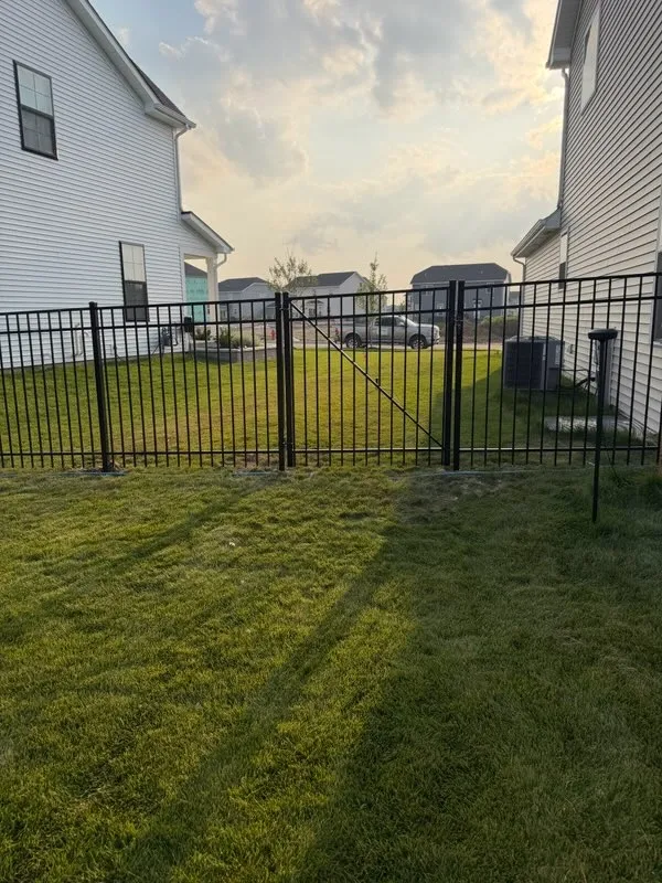 ornamental metal fence installed by top rail fence