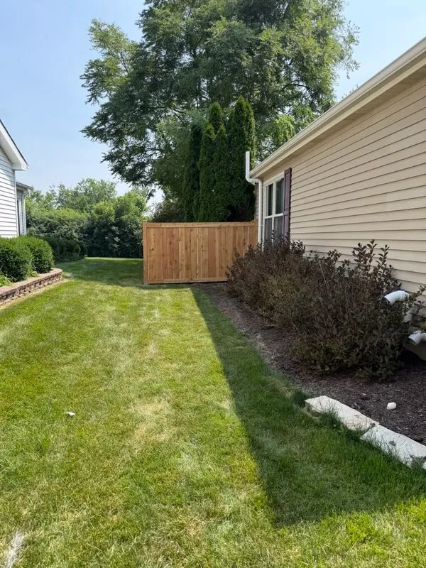 wood stockade fence installed by top rail fence