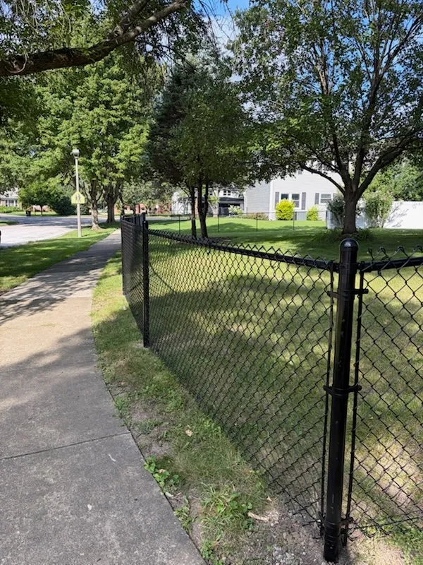 black chain link fence installed by top rail fence
