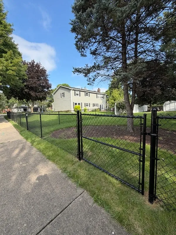 black chain link fence installed by top rail fence