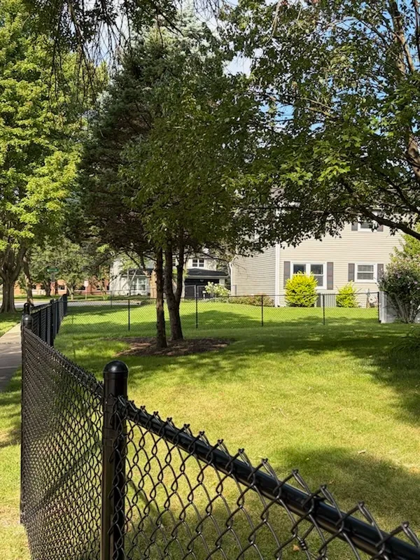 black chain link fence installed by top rail fence