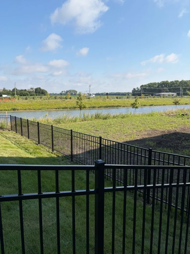 3 rail ornamental metal fence installed by top rail fence