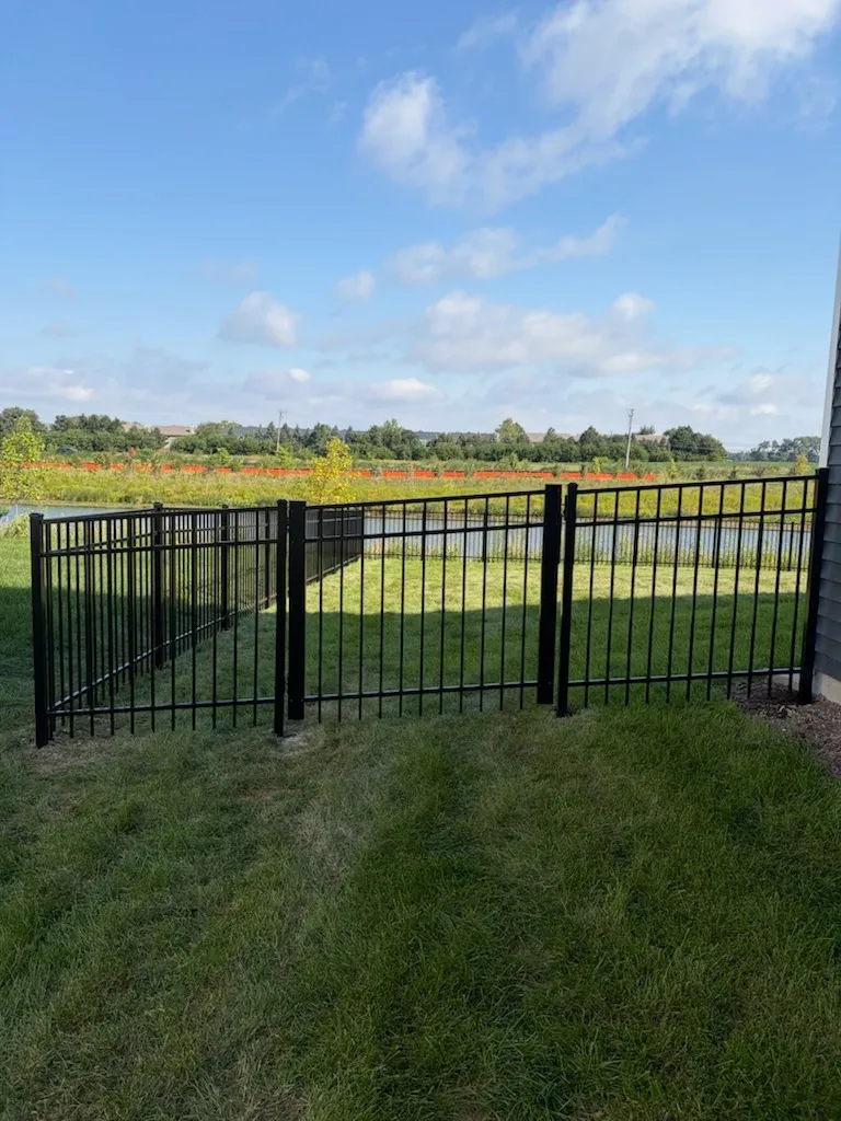 3 rail ornamental metal fence installed by top rail fence