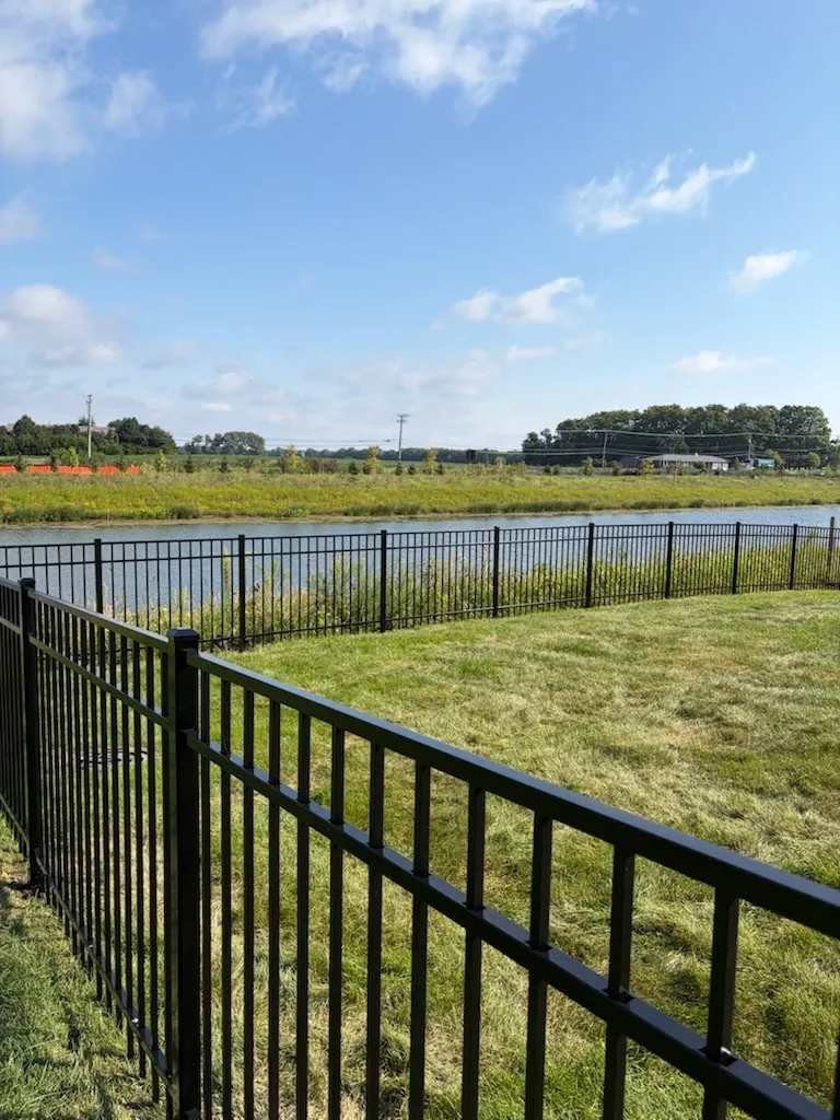 3 rail ornamental metal fence installed by top rail fence