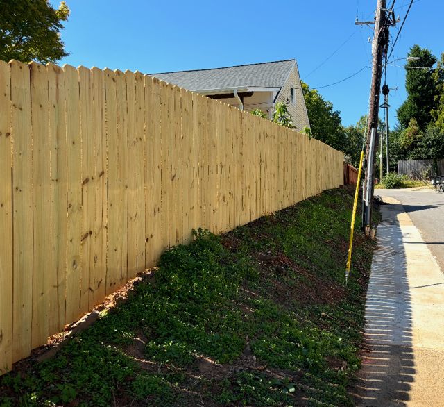 wood stockade fence installed by top rail fence