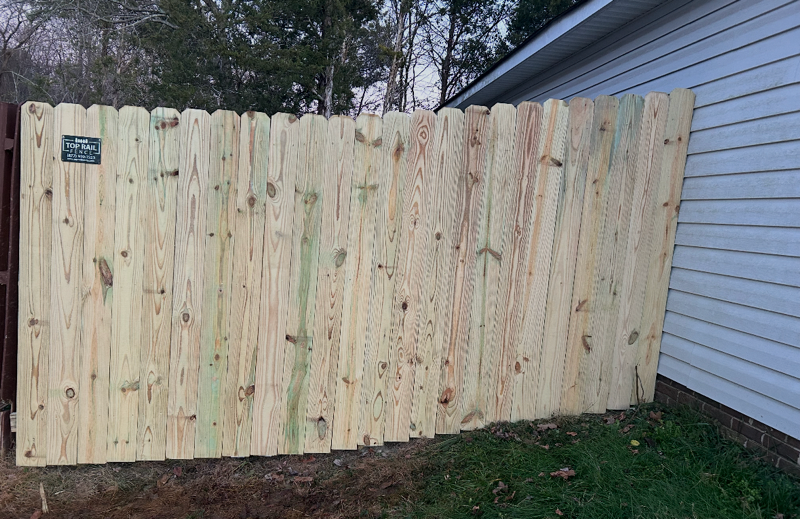 wood stockade fence installed by top rail fence