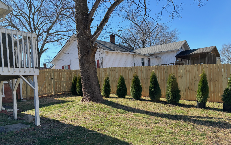 wood stockade fence installed by top rail fence
