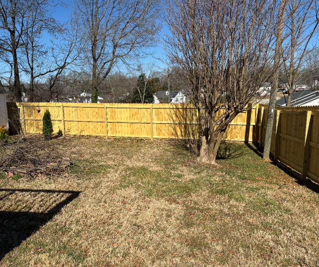 wood stockade fence installed by top rail fence