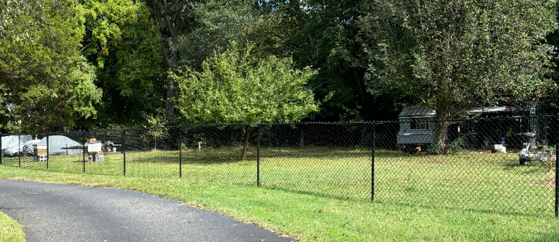 black chain link installed by top rail fence
