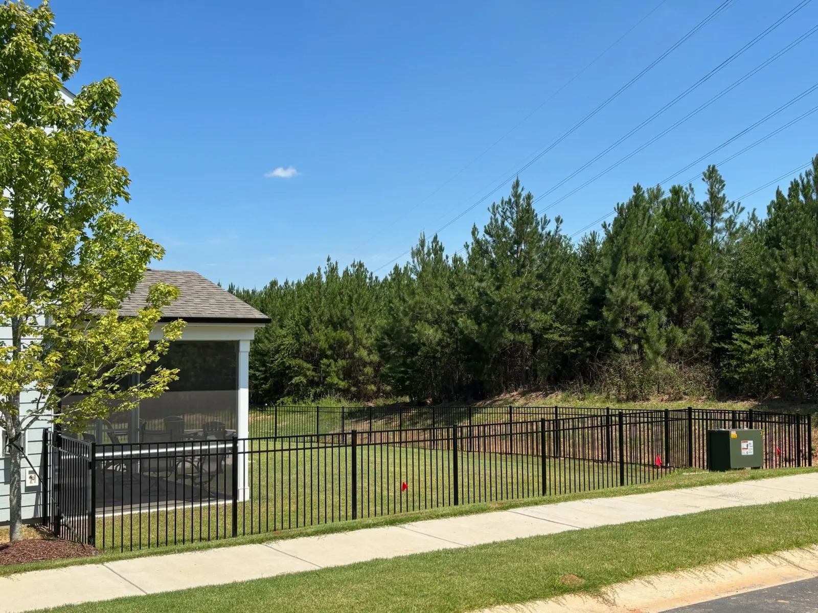 three rail ornamental metal fence installed by top rail fence