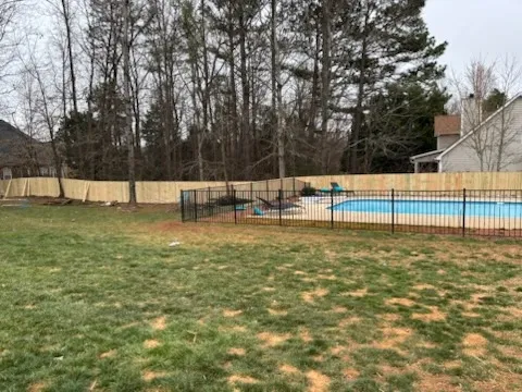 three rail ornamental metal fence installed by top rail fence