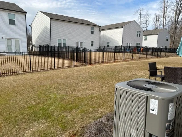 three rail ornamental metal fence installed by top rail fence