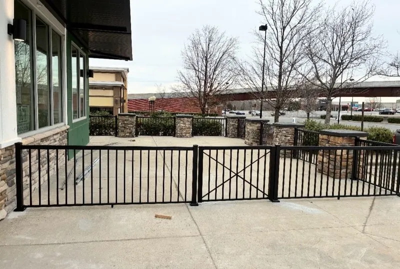 two rail ornamental metal fence installed by top rail fence