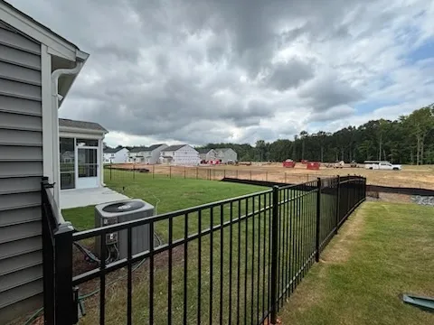 three rail ornamental metal fence installed by top rail fence