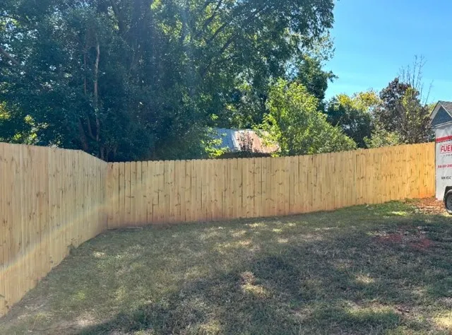 wood stockade fence installed by top rail fence