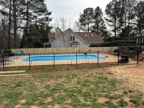 ornamental metal fence installed by top rail fence
