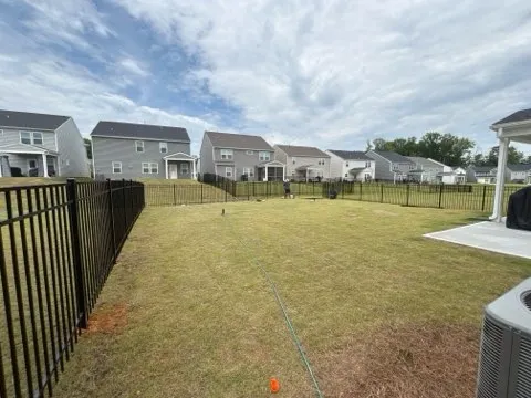 three rail ornamental metal fence installed by top rail fence