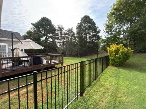 three rail ornamental metal fence installed by top rail fence