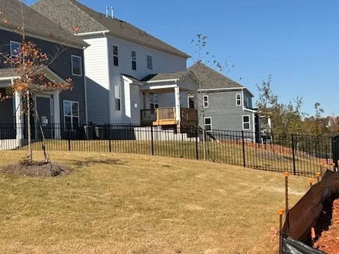 three rail ornamental metal fence installed by top rail fence