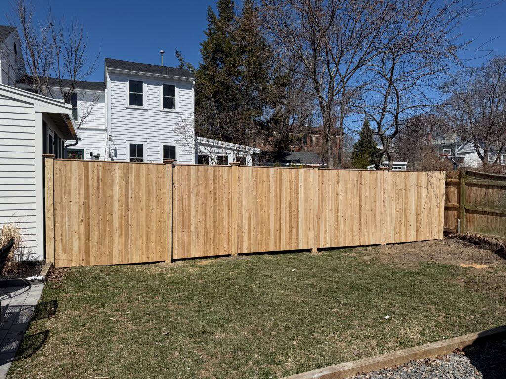 wood stockade fence installed by top rail fence