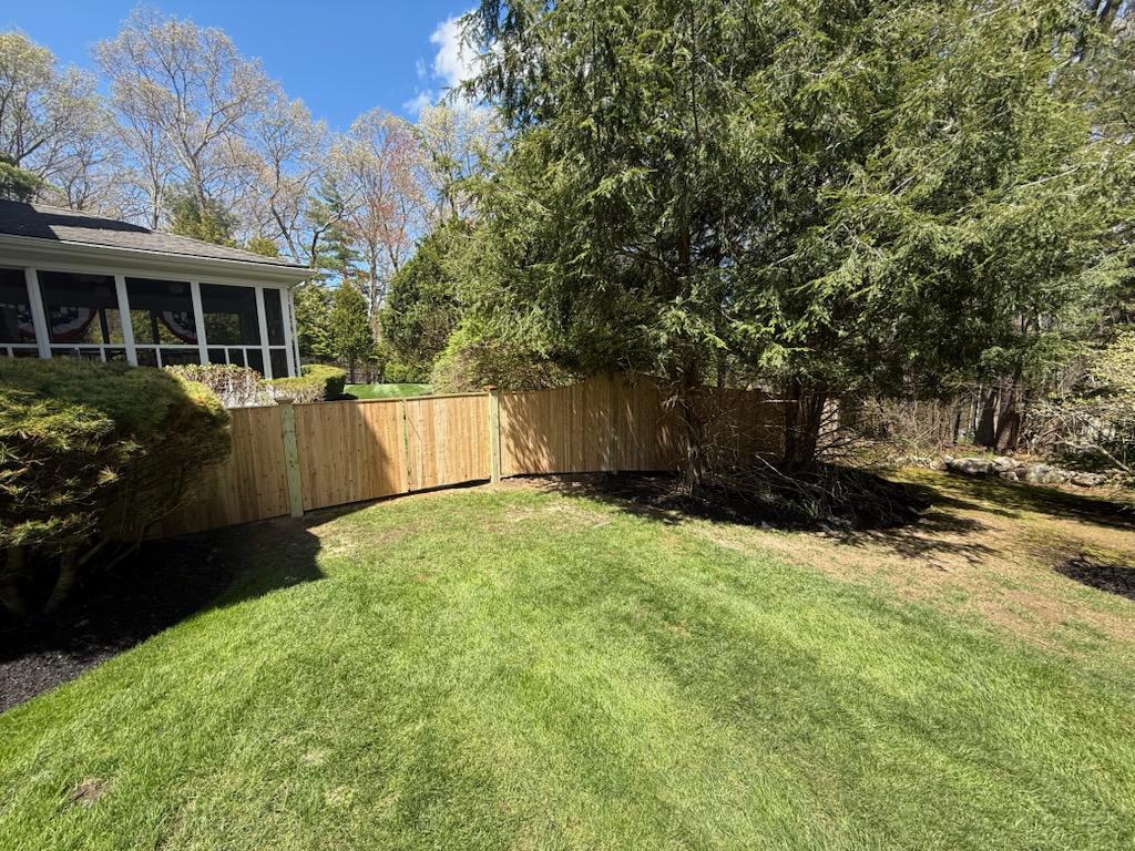 wood stockade fence installed by top rail fence