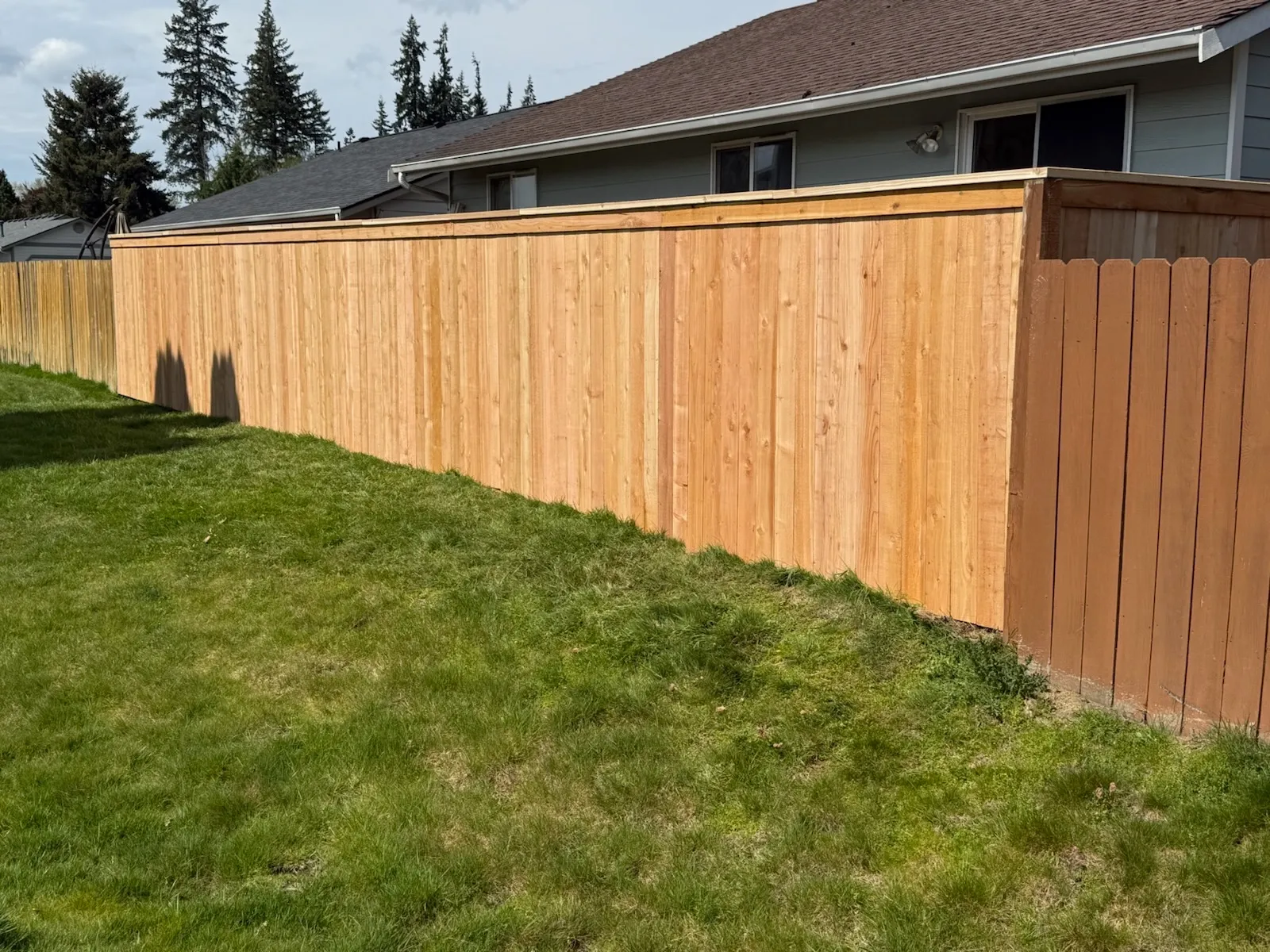 wood stockade fence installed by top rail fence