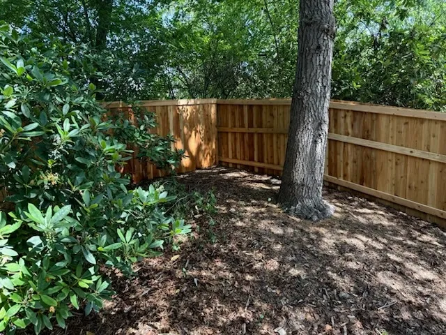 wood stockade fence installed by top rail fence