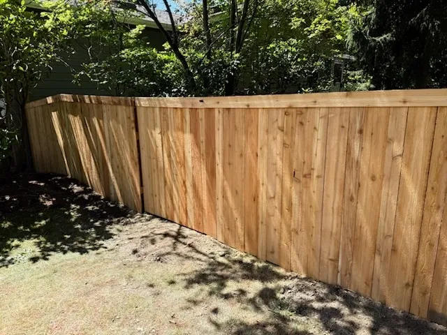 wood stockade fence installed by top rail fence