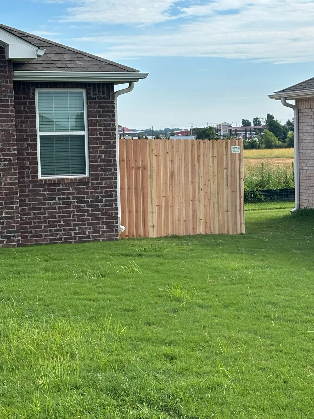 wood stockade fence installed by top rail fence