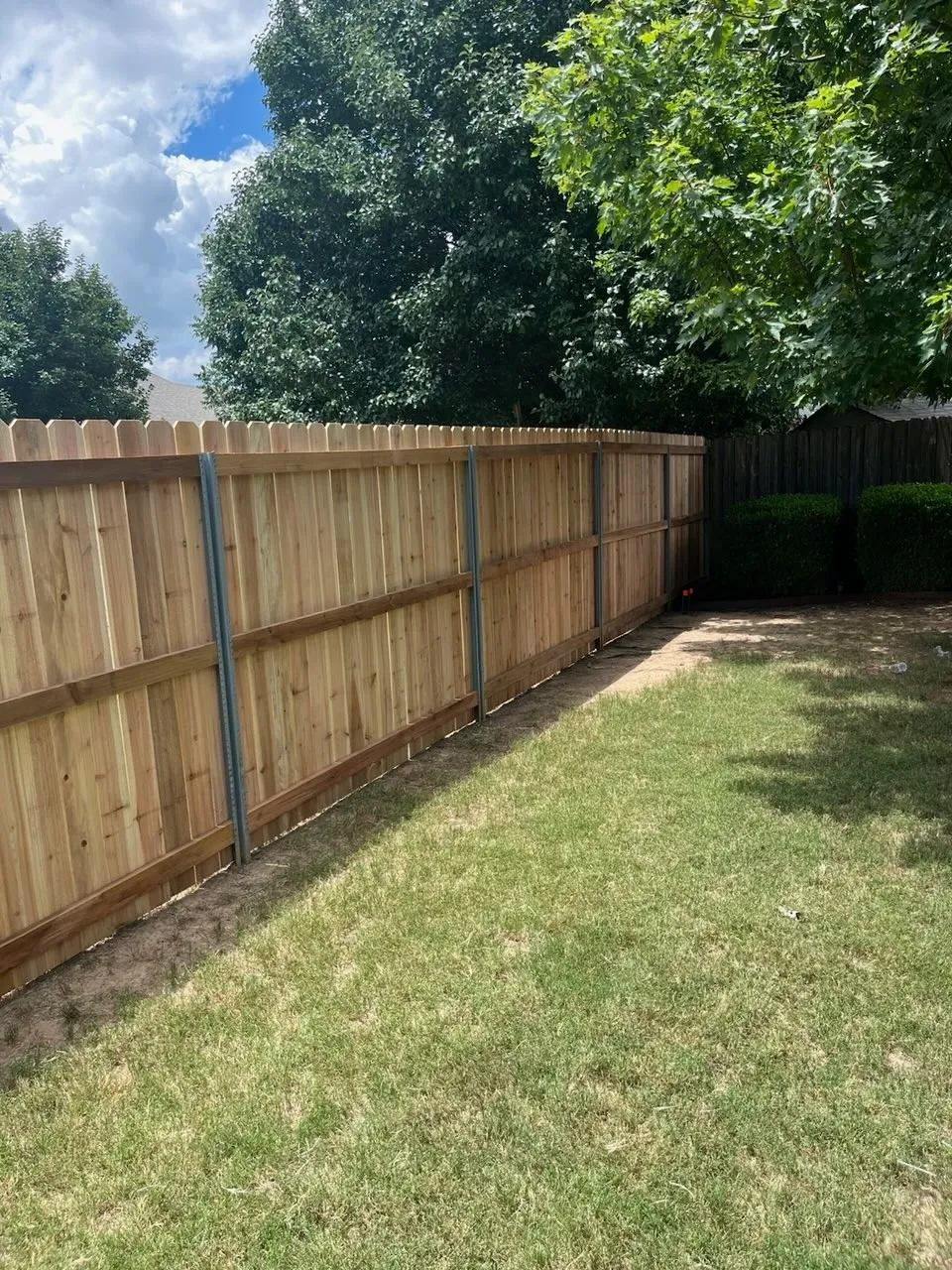 wood stockade fence installed by top rail fence