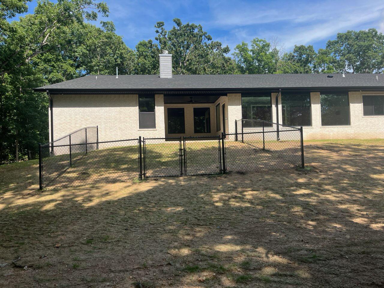 black chain link fence installed by top rail fence