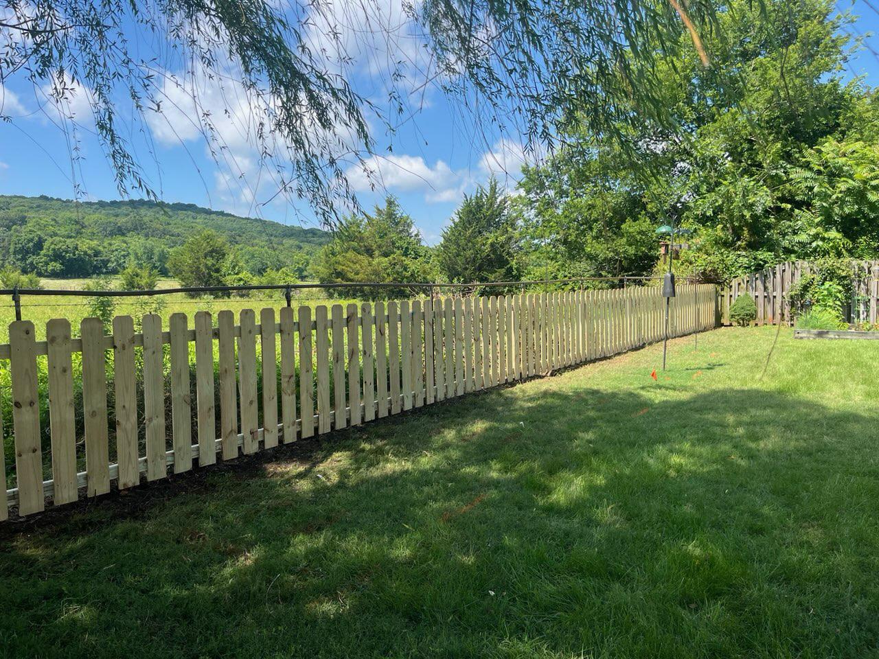 wood picket fence installed by top rail fence