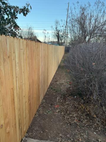 wood stockade fence installed by top rail fence