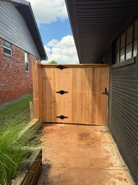 wood privacy gate installed by top rail fence