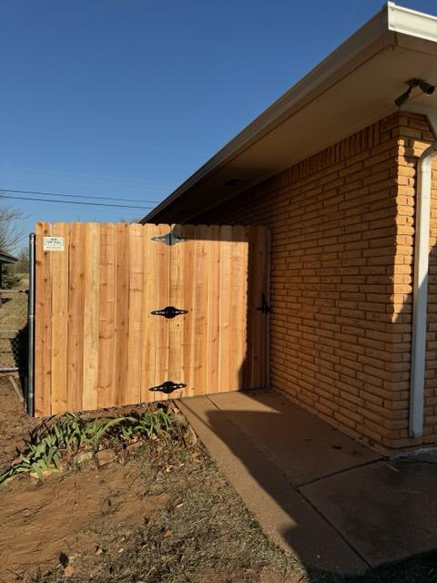 wood stockade fence installed by top rail fence