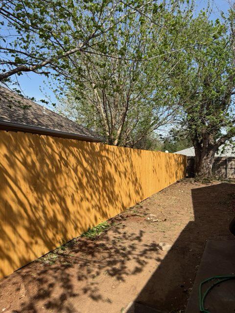 wood stockade fence installed by top rail fence