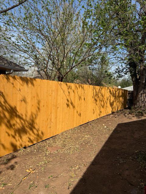 wood stockade fence installed by top rail fence