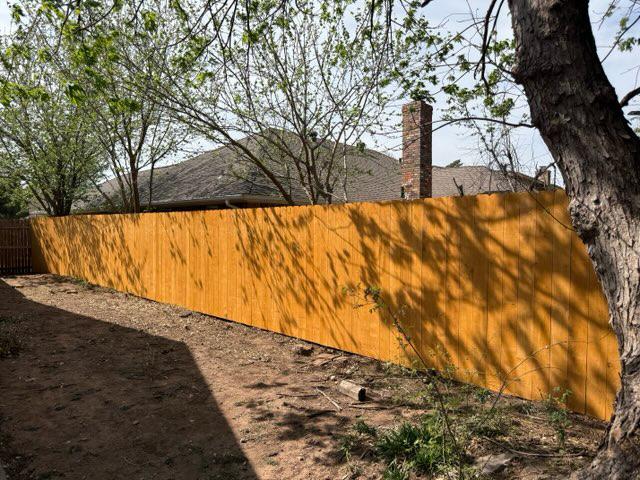 wood stockade fence installed by top rail fence