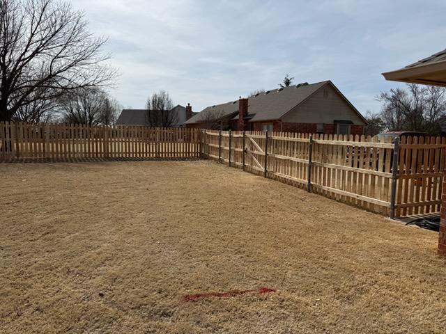 wood picket fence installed by top rail fence