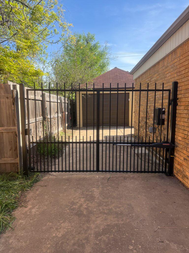 ornamental metal picket gate installed by top rail fence