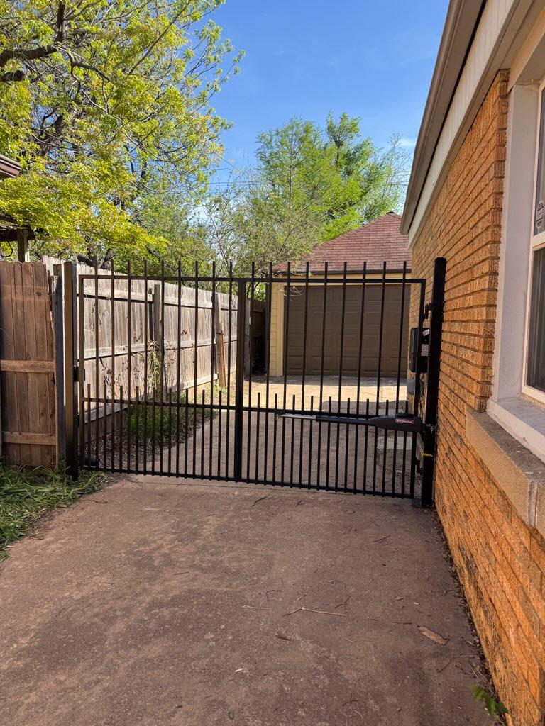 ornamental metal picket gate installed by top rail fence