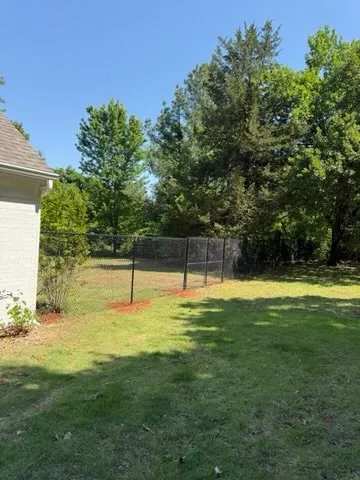 black chain link fence installed by top rail fence