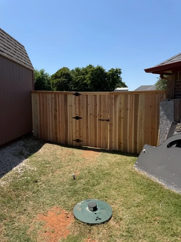 wood privacy gate installed by top rail fence