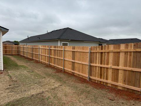 wood stockade fence installed by top rail fence