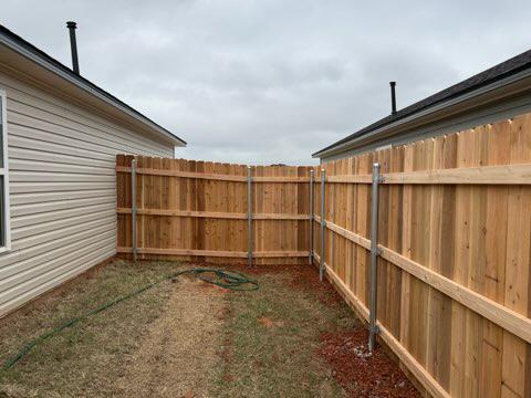 wood stockade fence installed by top rail fence