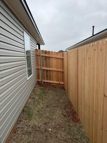 wood stockade fence installed by top rail fence